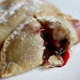 Mouthwatering dessert empanadas such as strawberry and chocolate, apple and cinnamon, guava and cheese...
