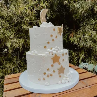 a white cake with gold stars