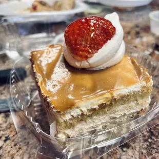 a piece of cake with a strawberry on top