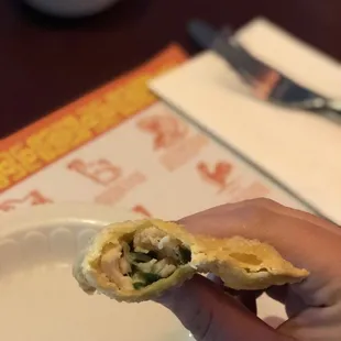 a hand holding a pastry