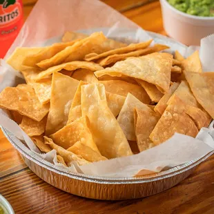 a basket of tortilla chips and guacamole