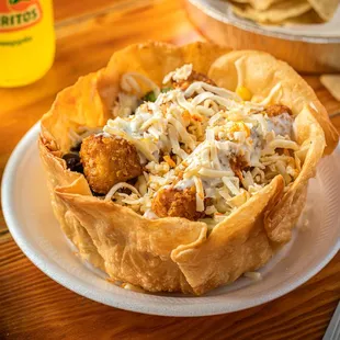 a taco bowl with a variety of toppings