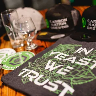 t - shirts and beer glasses on a table