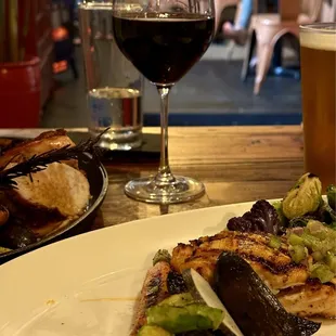 Grilled salmon, a glass of Sangiovese in the background.