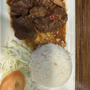 a plate of food with rice and meat