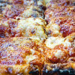 a thin crust pizza with cheese and pepperoni