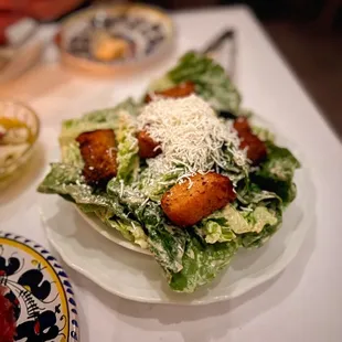 a plate of salad and a bowl of salad