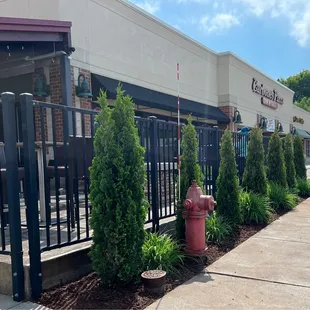 a red fire hydrant in front of the restaurant