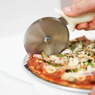pizza being sliced
