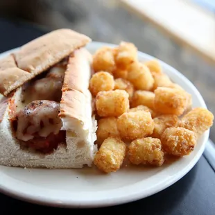 a sub sandwich and tater tots