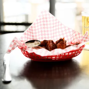 a basket of food and a glass of beer