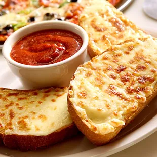 a slice of bread and a bowl of tomato sauce