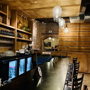 a bar with wine glasses on the counter