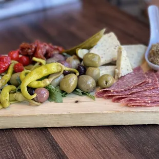 a platter of meat, cheese and olives