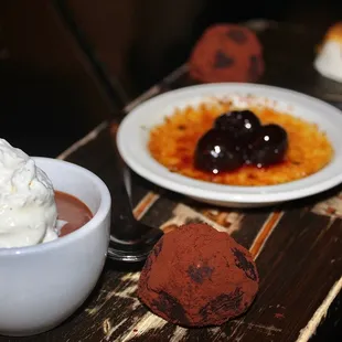 The Dessert Board came with Chocolate Pot De Creme, Salted Caramel Panna Cotta, Dark Truffles, &amp; Creme Brulee.