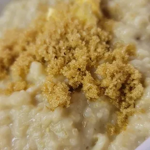 a bowl of oatmeal with crumbs