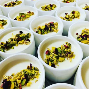 Mhalbia (rose water custard), crushed green pistachios, gold leaf