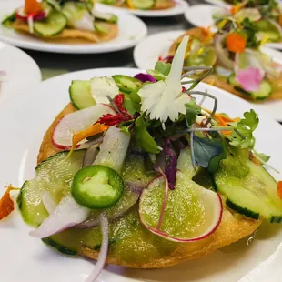 Scallop ceviche tostada, aguachile, shaved radish, Serrano peppers, edible flowers