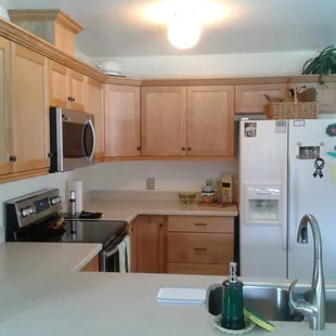 Crown molding and brass pulls complete the look on  the natural finished oak cabinets.
