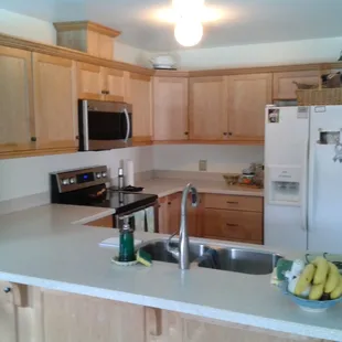 A lazy-susan and an easy access corner with a tilt-out tray under the sink were added to make the kitchen more functional.