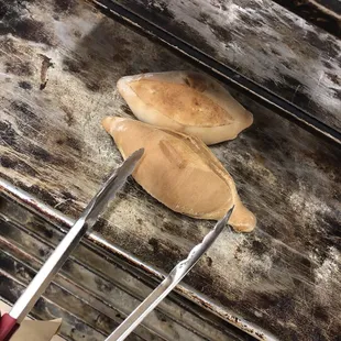 bread being cooked on a grill