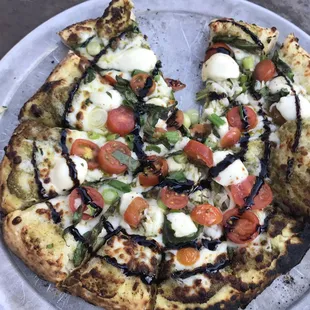A beautiful bruschetta pizza with a balsamic glaze at one of our summertime Outdoor Pizza Nights!