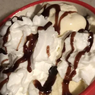 a bowl of ice cream and chocolate sauce