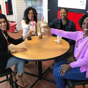 a group of women sitting around a table