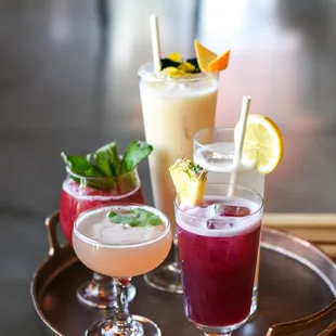 a variety of cocktails on a tray