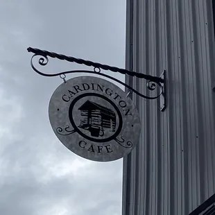 a sign hanging from the side of a building