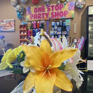 Table center piece with party supplies in the background.