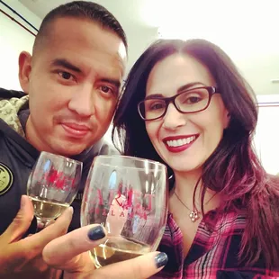 a man and a woman holding wine glasses