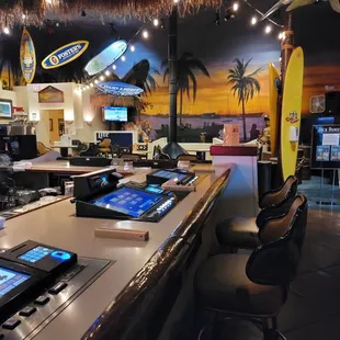 a bar with a surfboard on the wall