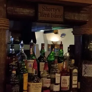 a shelf of liquor bottles