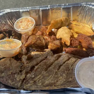 a tray of meat and sides