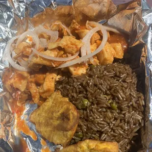 a plate of food wrapped in foil