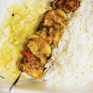 a chicken skewer and rice