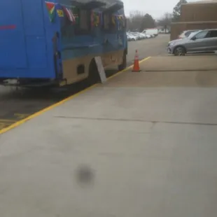 a blue bus parked in a parking lot