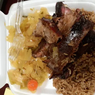 a white styrofoam container with meat and rice