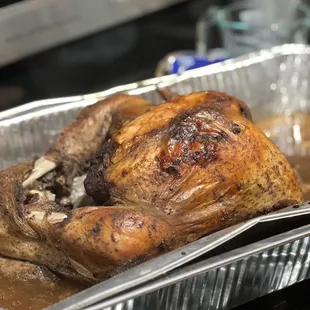 a roasting chicken in a foil pan