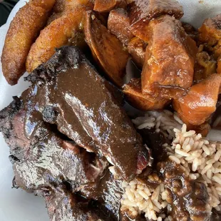 Large Chicken Meal with fried plantains and sweet yams. Jerk sauce on the rice and the chicken. Heaven.