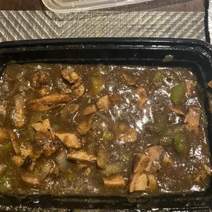 Jerk chicken pieces swimming in sauce