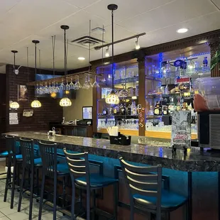 a bar with blue chairs