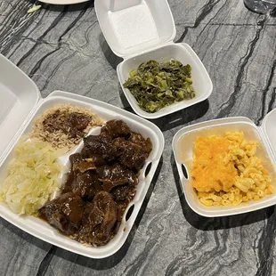 Oxtails, Mac and Cheese, greens, rice and beans