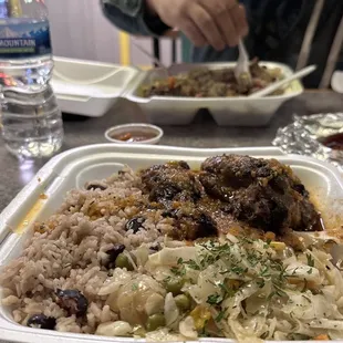 a tray of rice, meat, and vegetables