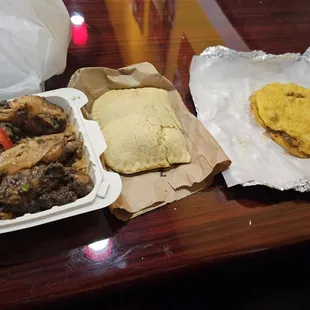 Left to right: Jerk wings with rice and peas, chicken patty, and doubles.