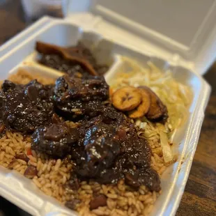 Oxtails, rice and peas, cabbage and plantains