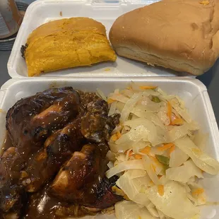 Jerk chicken with peas and cabbage, coco bread and a beef patty.