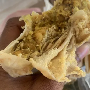 a hand holding a piece of food