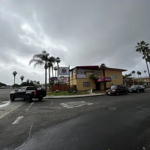 cars parked in front of a motel